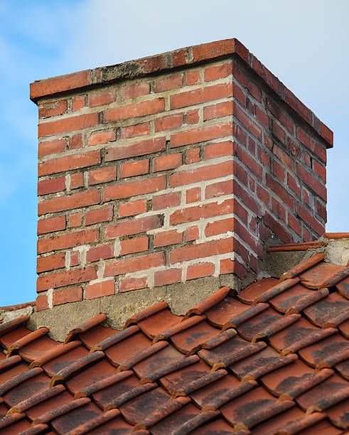 Weathered brick chimney stack showing worn joints